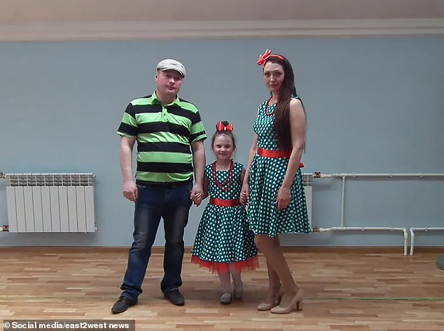 Mikhail Pichugin, 45, with his family, including his ex-wife Ekaterina, 38.