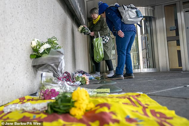 Members of the public left floral tributes to the former First Minister outside the Scottish Parliament.