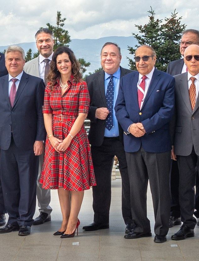 Alex Salmond can be seen smiling happily in the center of what is believed to be his last photo alongside his Alba Party president Tasmina Ahmed-Sheikh, who is wearing a tartan dress.