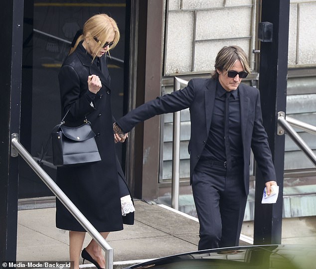 Nicole cut a sophisticated figure in a black dress with white lace trim, which she wore with black heels and a smart jacket to the funeral.