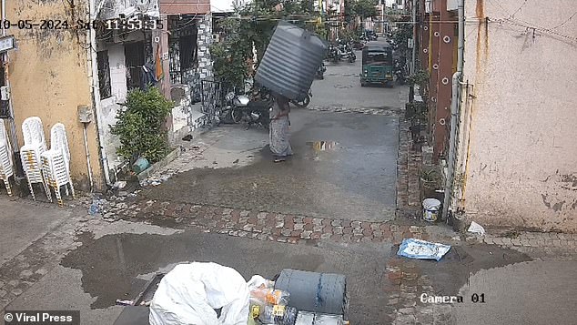 The image shows the moment just before the water tank fell on him