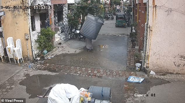 Instead of crushing her, the container landed perfectly on top of the woman and she was unharmed.