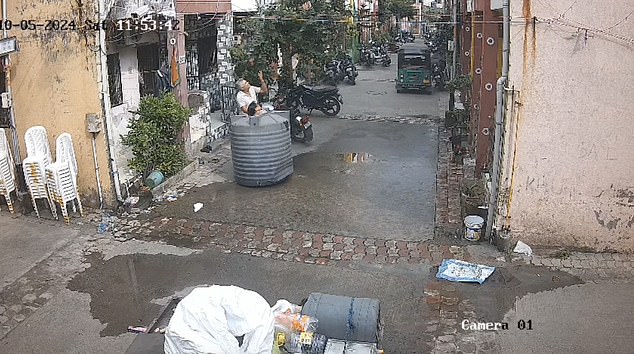 CCTV shows how his head even poked through a hole in the top of the plastic drum.