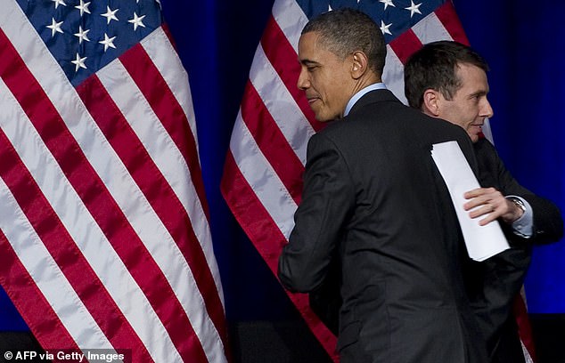 President Barack Obama greets senior advisor and former campaign manager David Plouffe (L) during a Democratic National Committee (DNC) event in Washington, DC, on March 16, 2011.