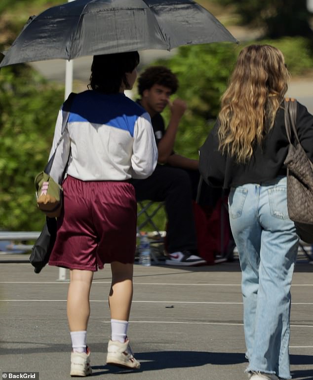 She was wearing a loose-fitting blouse and plum-colored shorts, paired with a wig.