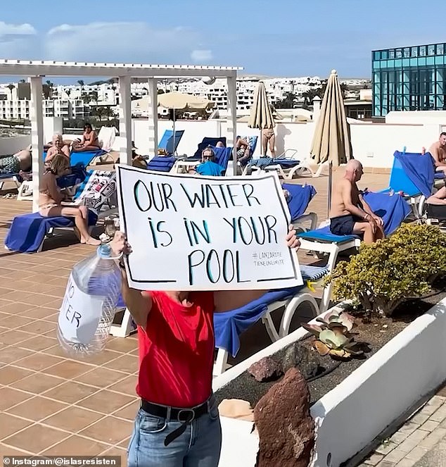 A protester holds a sign that says 