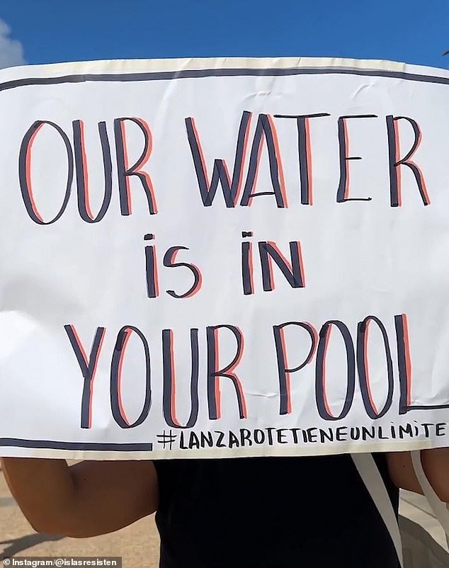 Slogan 'Our water is in your pool' carried by a member of the activist group 'Lanzarote has a limit'