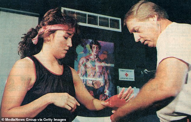 Professional boxer Christy Martin prepares for a training session with her husband and trainer Jim Martin.