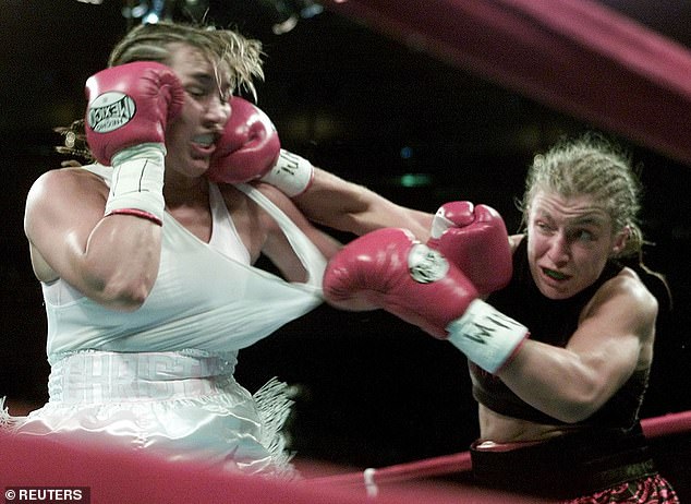 WBC and WBA women's champion Christy Martin (left) is hit in the head by her opponent Kathy Collins during their fight in New York on May 12, 2001. Martin retained her titles with a 10-round decision