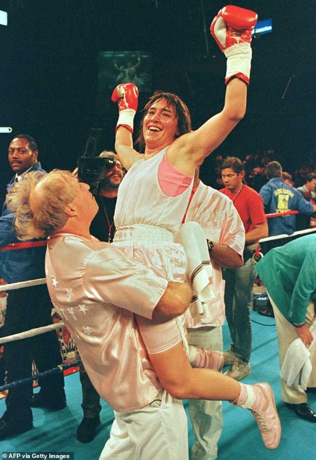 Martin lifting Christy after she knocked out challenger Melinda Robinson in the fourth round of the Women's Pound-For Boxing Championship in Las Vegas, Nevada, at the MGM Grand Garden.