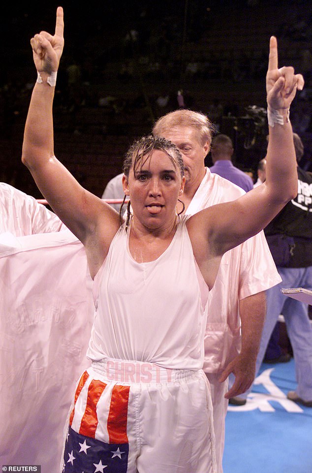 Christy Martin celebrates her victory over Lisa Holewyne of Austin, Texas during the Pound for Pound Women's Championship at the Mandalay Bay Hotel and Casino in Las Vegas, November 17, 2001. Martin won the fight by unanimous decision