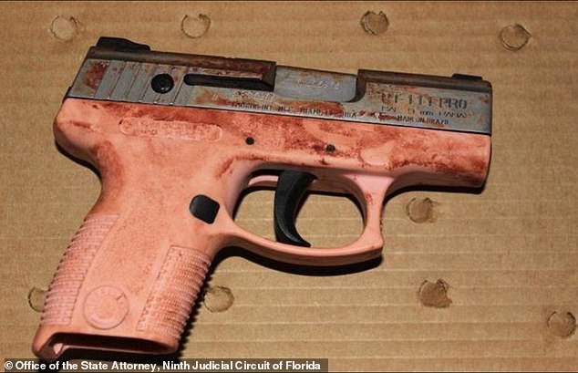 The pink 9mm pistol Martin used when he opened fire on his wife, shooting her in the chest. The gun has blood marks.