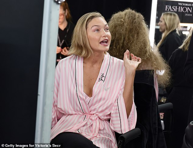 She wore a custom Victoria's Secret robe as she sat down to do her hair and makeup.