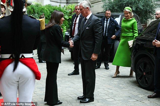 King Philippe, pictured shaking hands with the mayor of Paris