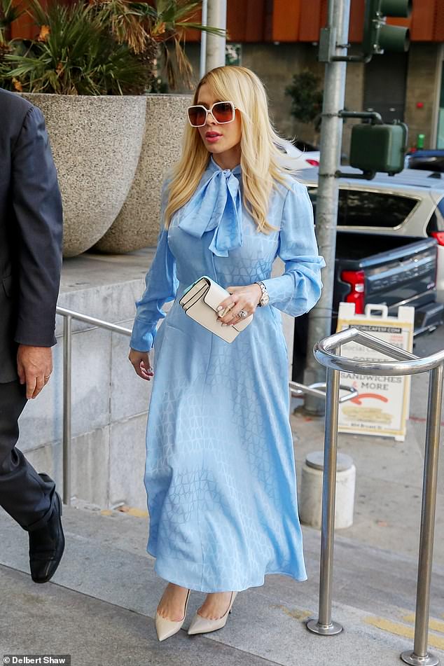 The blonde bombshell, who is expected to testify, accessorized the look with large white-framed glasses, a small white clutch and beige heels.