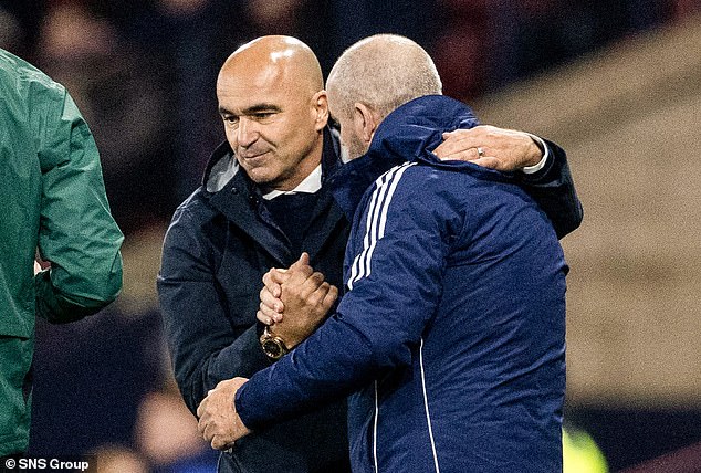 Managers Martínez and Clarke hug at the end of the game.