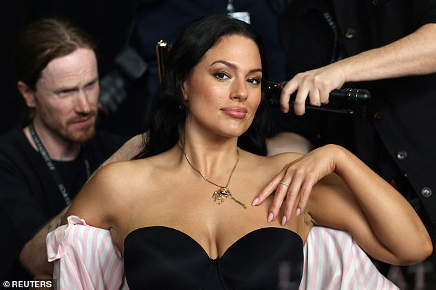 Plus size model Ashley Graham looked sensational in a strapless black bra as her glam team put the finishing touches on her hair and makeup.