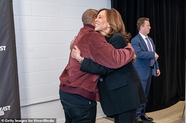 Democratic presidential candidate Vice President Kamala Harris (R) and Charlamagne Tha God hug before their interview at City Hall in Detroit, Michigan.