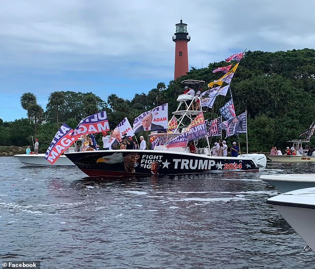 A huge boat is seen full of Trump flags and a sticker surrounding it with the presidential candidate's face.