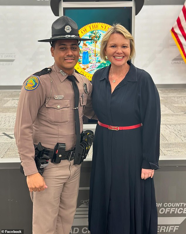 Florida Highway Patrol Trooper Orlando Morales (left) received a tip about the animal and found it in the grassy area.