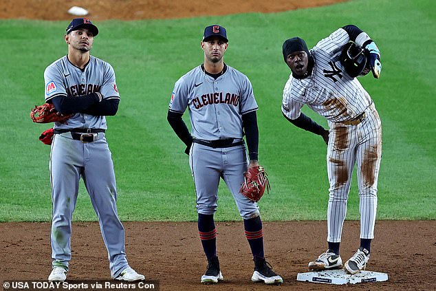 Jazz Chisholm (right) waits to learn his fate after being thrown out at second base.