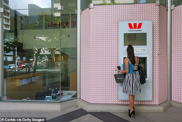 To further complicate matters for those who prefer cash, half of the ATMs used in Australia have been decommissioned since 2019 (pictured, an ATM in Sydney).