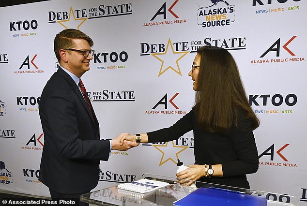 Republican House candidate Nick Begich and Democratic incumbent Rep. Mary Peltola shake hands after a debate.