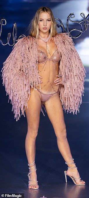 The model put on a leggy display in the skimpy pink underwear.