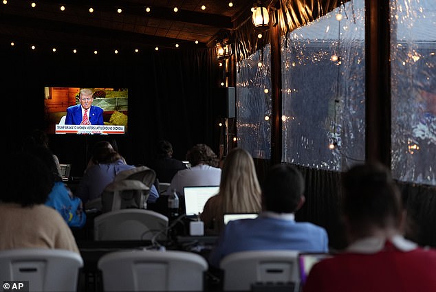 Reporters watch as former President Donald Trump, Republican presidential candidate, speaks during a Fox News town hall with Harris Faulkner at The Reid Barn, Tuesday, Oct. 15, 2024.