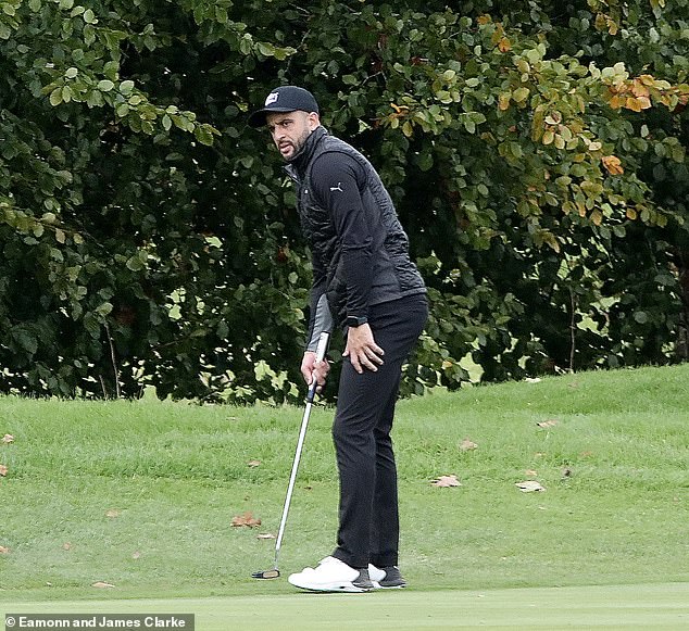 Footballer Kyle is seen playing a round of golf in Cheshire yesterday afternoon.