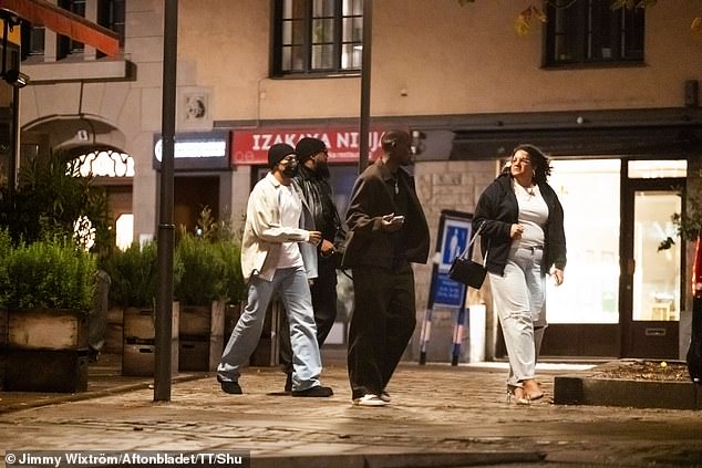 Mbappé (wearing a black hat and mask) is seen with his entourage outside the Chez Jolie restaurant.