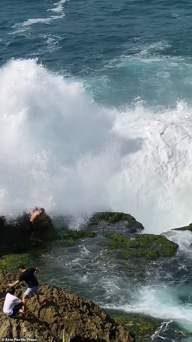 The huge wave crashed into him as his friends watched in horror.