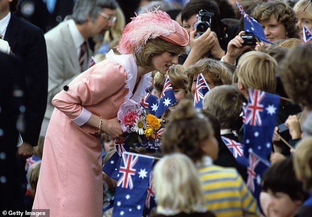 Diana, wearing a peach dress designed by Bellville Sassoon, is greeted by the public during a walk on March 25, 1983 in Canberra.