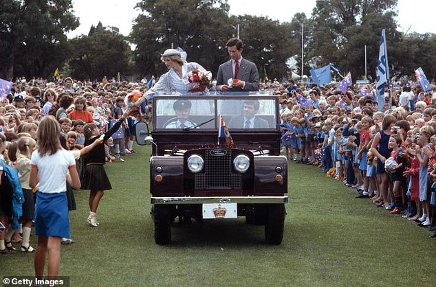 The couple were riding a Land Rover at the Hands Oval sports ground in Western Australia as Diana accepts gifts from the children.