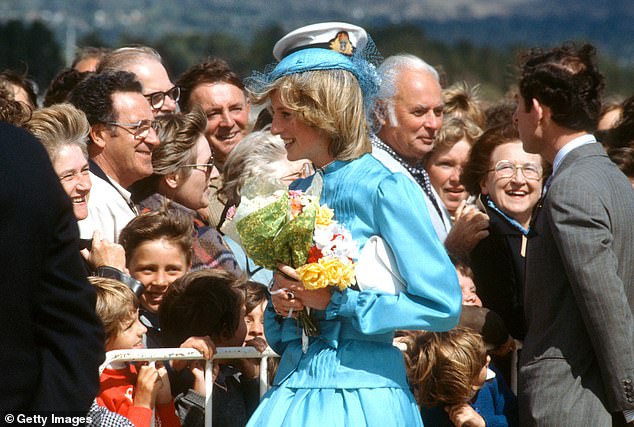 Holding flowers, Diana speaks to supporters with Charles as they arrive at the RAAF base at Fairbairn in Canberra, Australia.