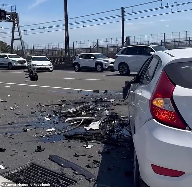 Scrap metal, broken glass and fluid from the accident were scattered on both sides of the road.