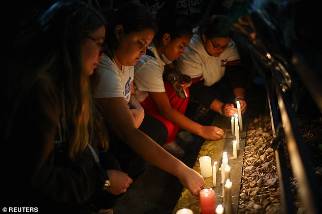 Fans place candles outside the Casa Sur Hotel in Buenos Aires, Argentina, yesterday.