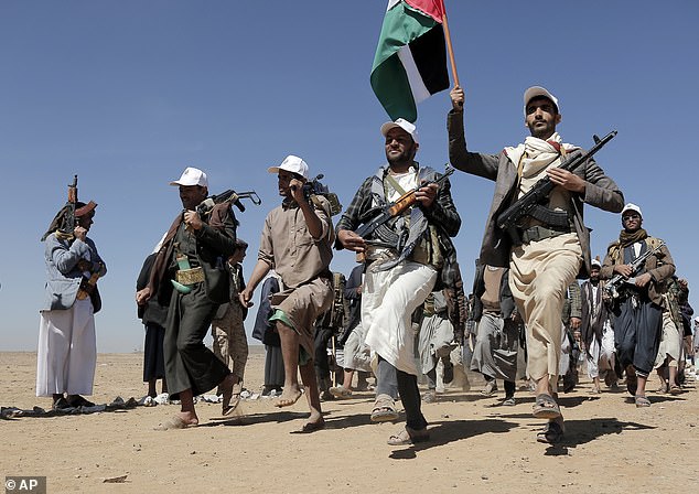 Houthi attacks in the Red Sea have forced major shipping companies to avoid the waterway, affecting international trade. Pictured: Houthi rebel fighters march during a rally in support of Palestinians in the Gaza Strip and against US attacks in Yemen on the outskirts of Sana'a on January 22, 2024.