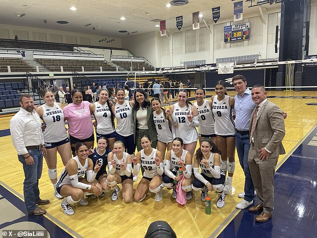 The team poses with Gabbard and Brown (second right) at Tuesday night's game.