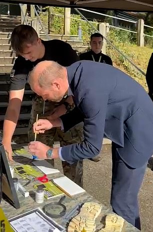 GETTING YOUR HANDS DIRTY: The royal is seen learning how to use fingerprints during an exercise.