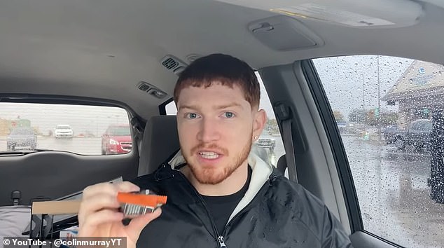 Mr Murray is pictured above trying one of the protein bars while in his car.