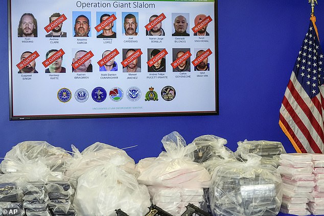 At a demonstration, prosecutors show the items that authorities seized from the drug trafficking network. This included more than a ton of cocaine, dozens of rounds of ammunition, and more than $3 million in cryptocurrency.