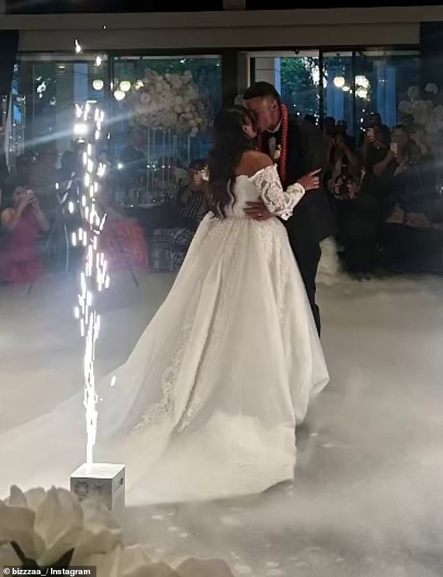 The happy couple shares their first dance as husband and wife in their formal attire