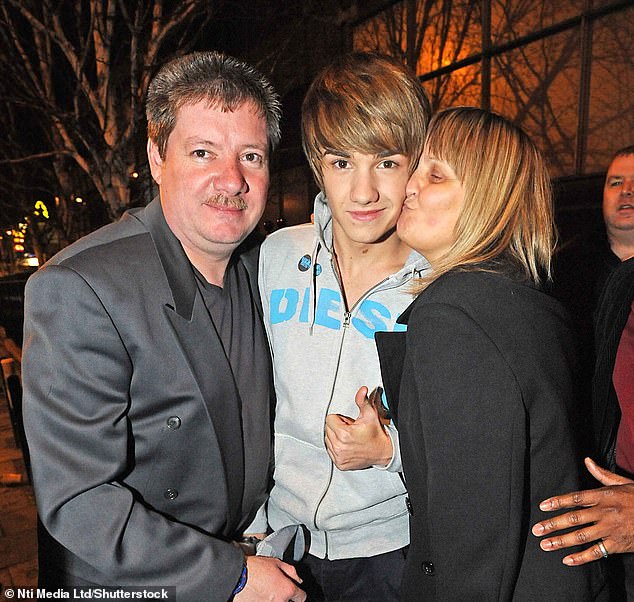 Liam Payne with his father Geoff and mother Karen after the X Factor final in London in 2010