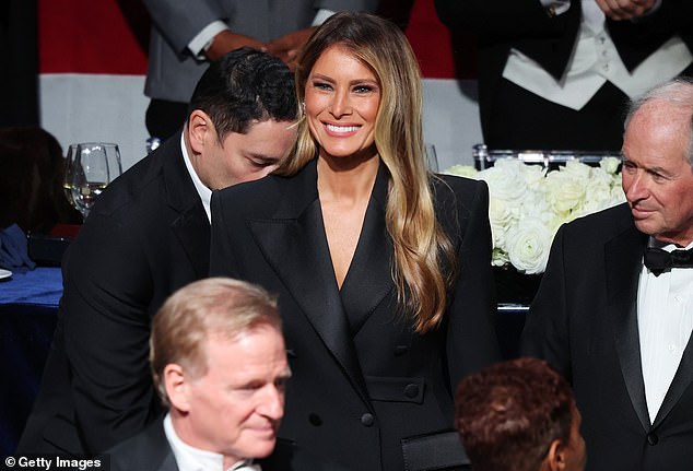 Melania wears a dazzling smile.