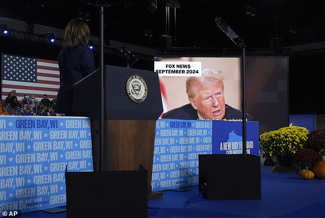 Harris watching a video showing clips of Trump talking about abortion rights and overturning Roe at his rally in Green Bay. She has introduced him in her own words at multiple events in recent days.