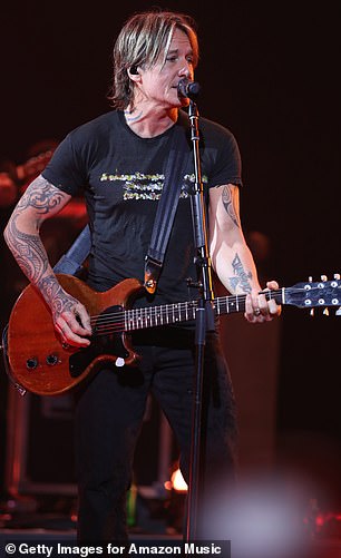 The Somebody Like You hitmaker looked casual for the concert, wearing a simple black T-shirt with what appeared to be a graphic pattern painted on the front.