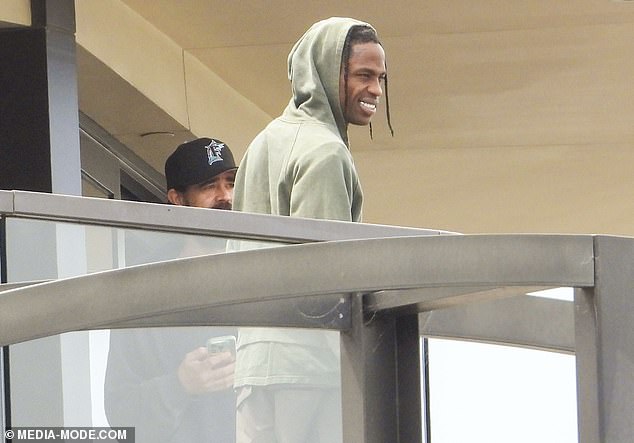 Travis was joined by a handful of his entourage on the enormous balcony.