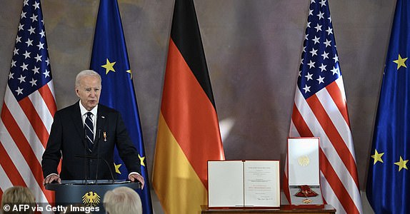 US President Joe Biden delivers his acceptance speech after German President Frank-Walter Steinmeier (below right) awarded him the Special Class Grand Cross of the Order of Merit (Bundesverdienstkreuz), the civilian award tallest in Germany, during a ceremony in Bellevue. palace, in Berlin, on October 18, 2024. The president of the United States visits Germany on a whirlwind trip to the NATO ally, and Western support for Ukraine will be high on the agenda in talks with the German chancellor. (Photo by RALF HIRSCHBERGER/AFP) (Photo by RALF HIRSCHBERGER/AFP via Getty Images)