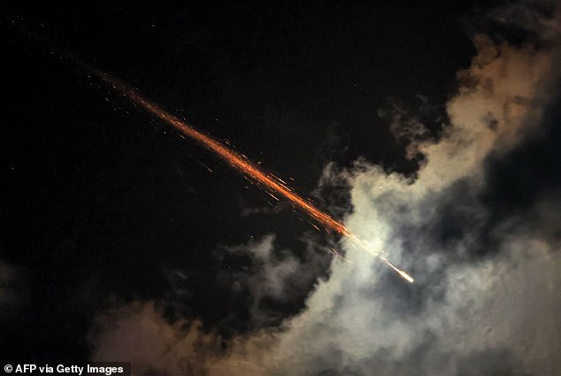 A missile breaks up in mid-air after being hit by an interceptor fired by one of Israel's air defense systems.